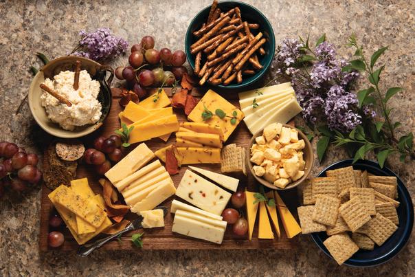 Cheese crackers and pretzels on a board