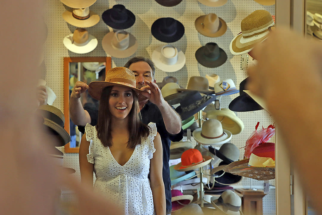 Man places a hat on a woman